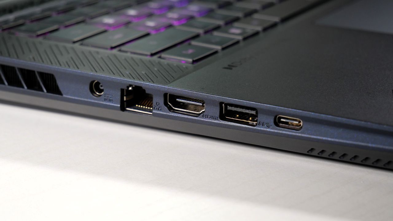 Gigabyte Aorus Master 16 (RTX 5080) open on a white table, highlighting the ports on the left, including the power, Ethernet, HDMI, USB Type-A, and USB Type-C.