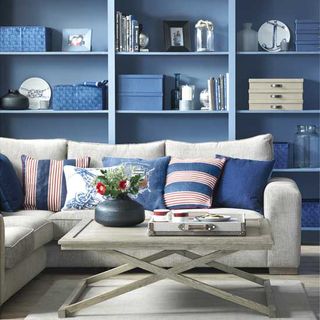 living room with blue wall and shelf on wall wooden table