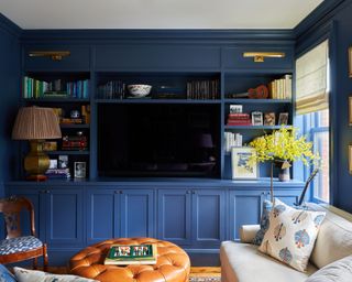 dark blue living room with built in shelving
