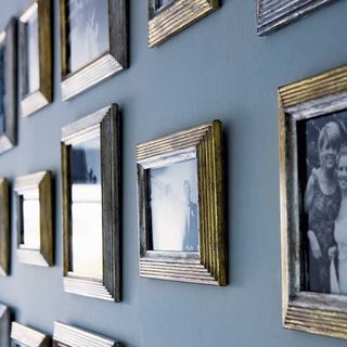 hallway with grey wall and photo frames on wall