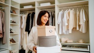 A woman organising boxes in her bedroom