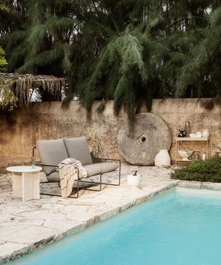 Outdoor living with pool, rattan furniture, lounger