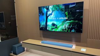 TCL X937U soundbar in trade show booth with TCL TV