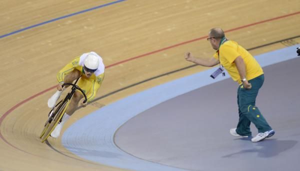 An Australian coach shouts out time checks for the team sprinters