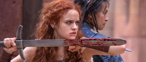 Joey King and Veronica Ngo bloodied, holding their swords in battle in The Princess.