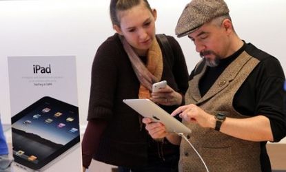 Customers check out the newly-released iPad at the San Francisco Apple store.