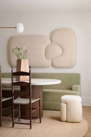 Dining room with shapely table, stool and wall art