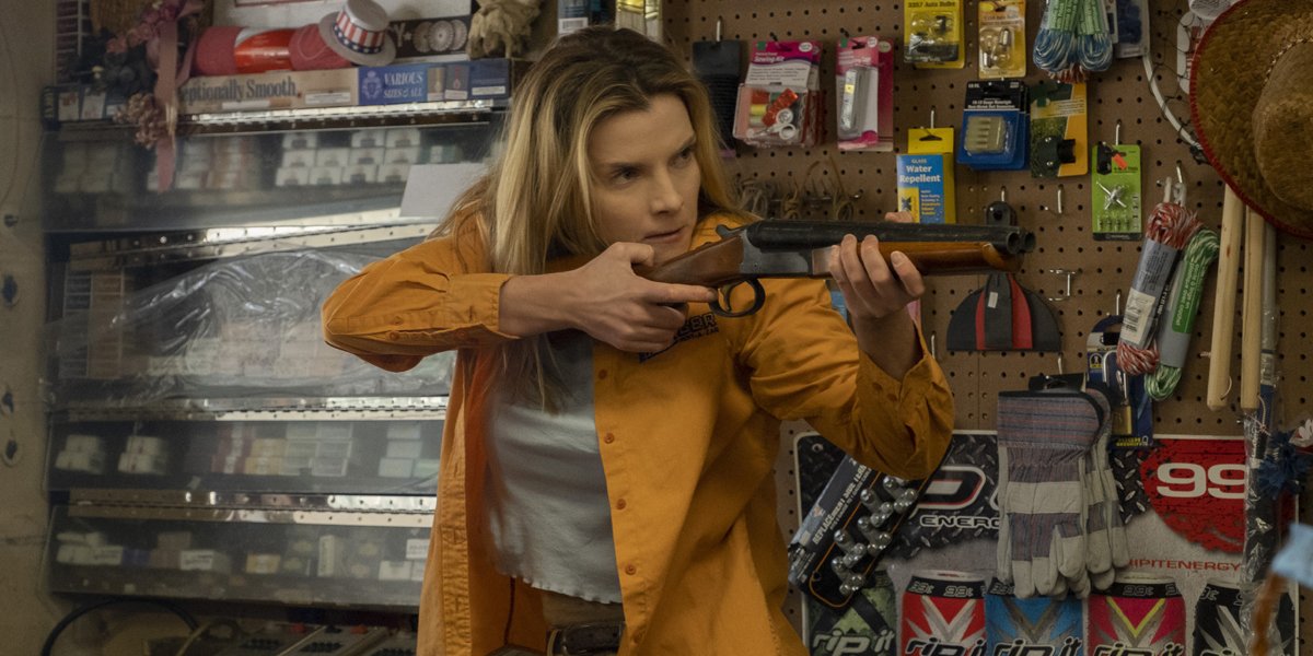 Betty Gilpin as Crystal holding a gun in The Hunt