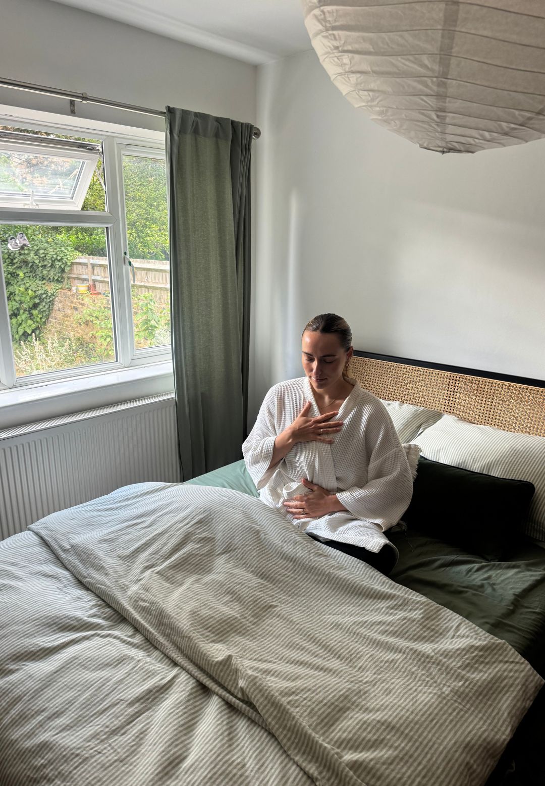 Health writer Georgia Brown on her bed after trying ten minutes of pre-bed yoga