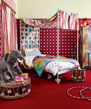 kids room with red carpet and awning above the bed