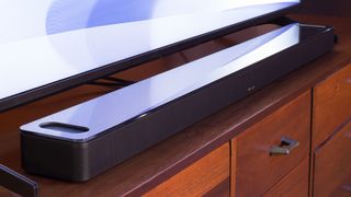 Hero image for best Dolby Atmos soundbars showing the Bose Smart Ultra Soundbar underneath a TV