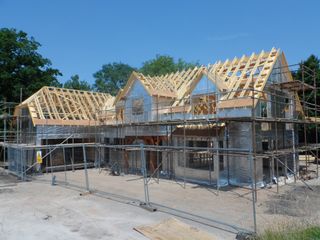 a timber frame home under construction