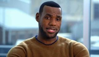 Trainwreck Lebron James sits in front of a window