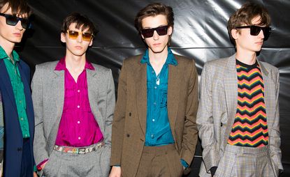 4 male models wearing sunglasses & brightly coloured shirts