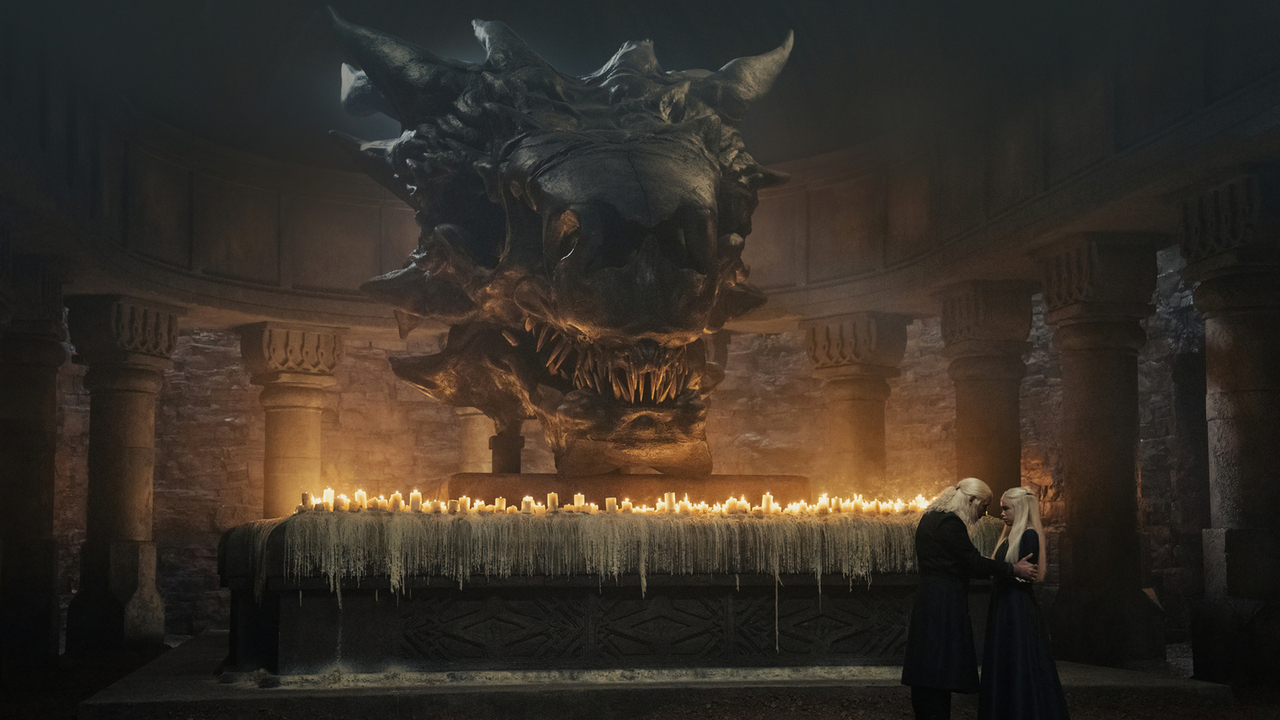 Viserys and Rhaenyra in front of a dragon skull in House of the Dragon