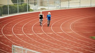 Two women race walking on a track