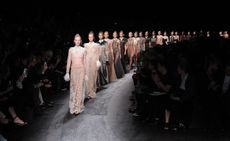 Models wearing Valentino designers Maria Grazia Chiuri and Pierpaolo Piccioli's outfits