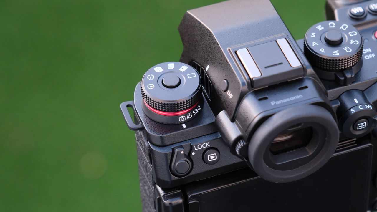 Close up of the dials and buttons on a Panasonic Lumix S1R II camera top panel