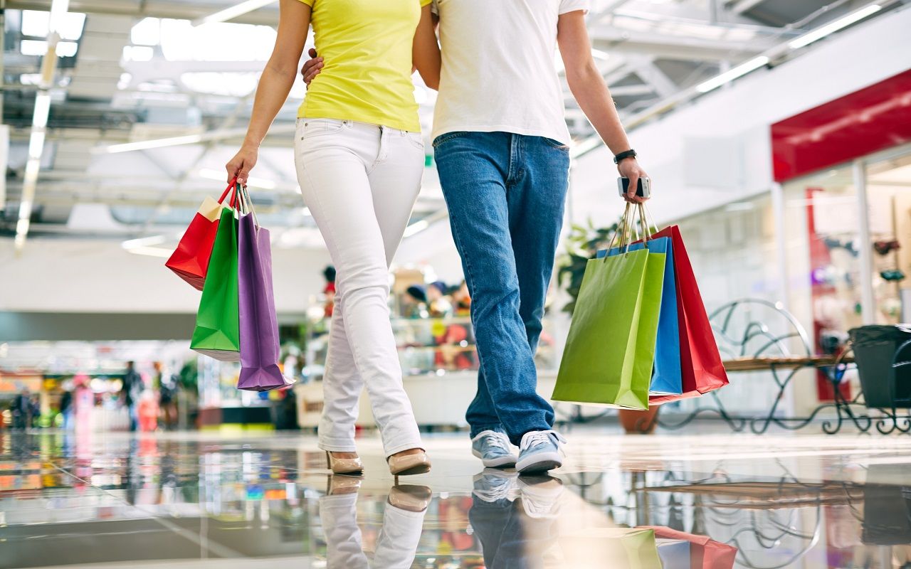 Legs of young couple going in the mall