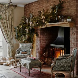 inglenook fireplace decorated with a festive garland with ribbons