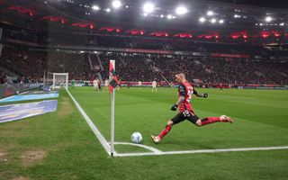 Alex Grimaldo of Bayer Leverkusen shots a corner during the Bundesliga match between Bayer 04 Leverkusen and FC Bayern München at BayArena on February 15, 2025 in Leverkusen, Germany.