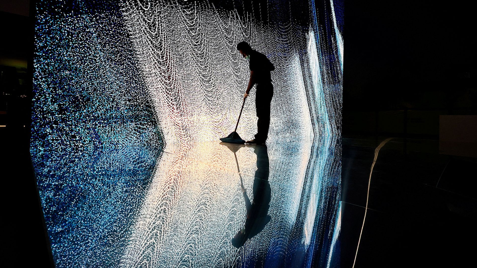 
                                A cleaner mops the floor near an art installation ahead of the Noor Riyadh light festival in Riyadh, Saudi Arabia
                            