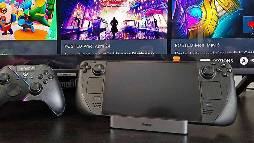 Baseus 6-in-1 Steam Deck dock with OLED model sitting in cradle next to Asus controller and Samsung TV with game menu in backdrop.