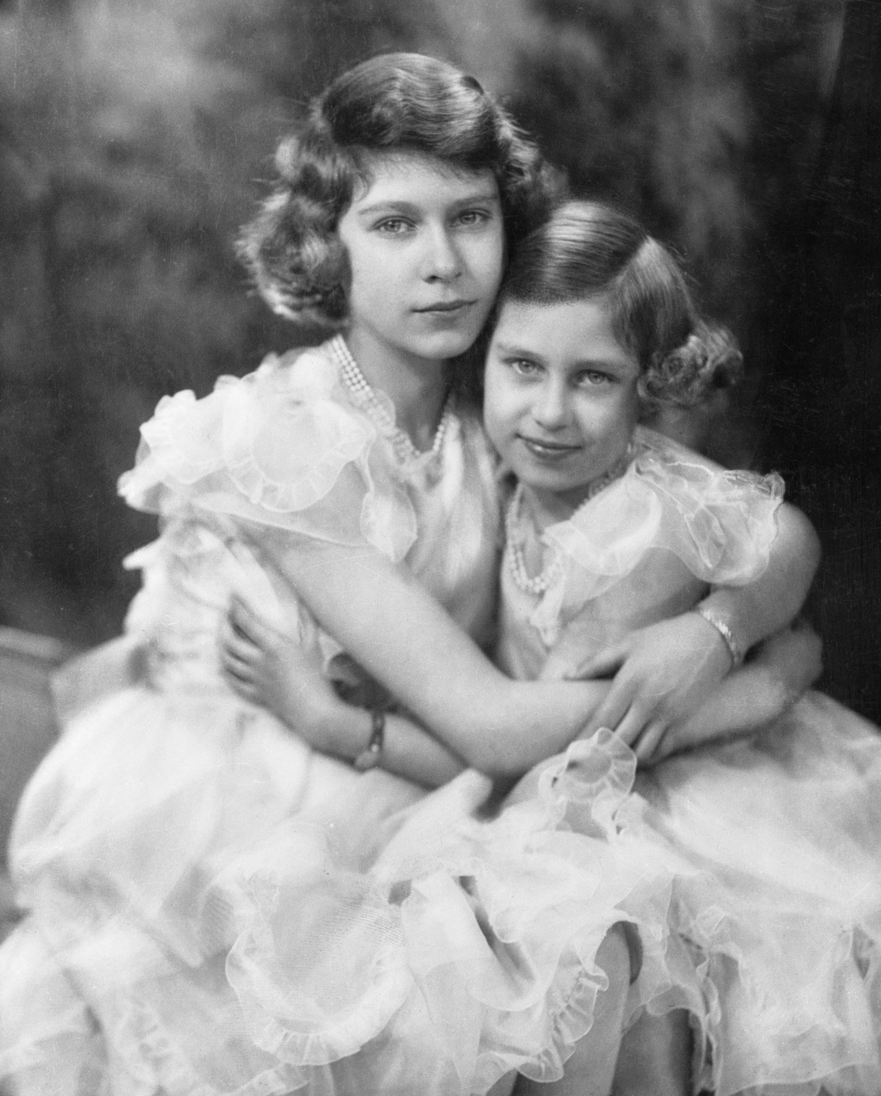 Queen Elizabeth and Princess Margaret hugging as children