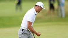 Haotong Li celebrates holing a putt at The Open