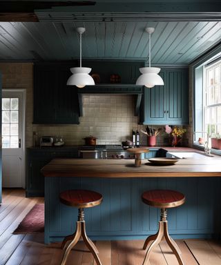 Built-in kitchen with blue cabinetry and peninsular with bar stools