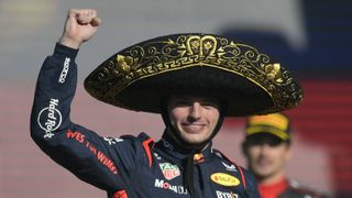 Red Bull Racing's Dutch driver Max Verstappen, wearing a black and gold sombrero hat, celebrates on the podium after winning the Formula One Mexico Grand Prix at the Hermanos Rodriguez racetrack in Mexico City