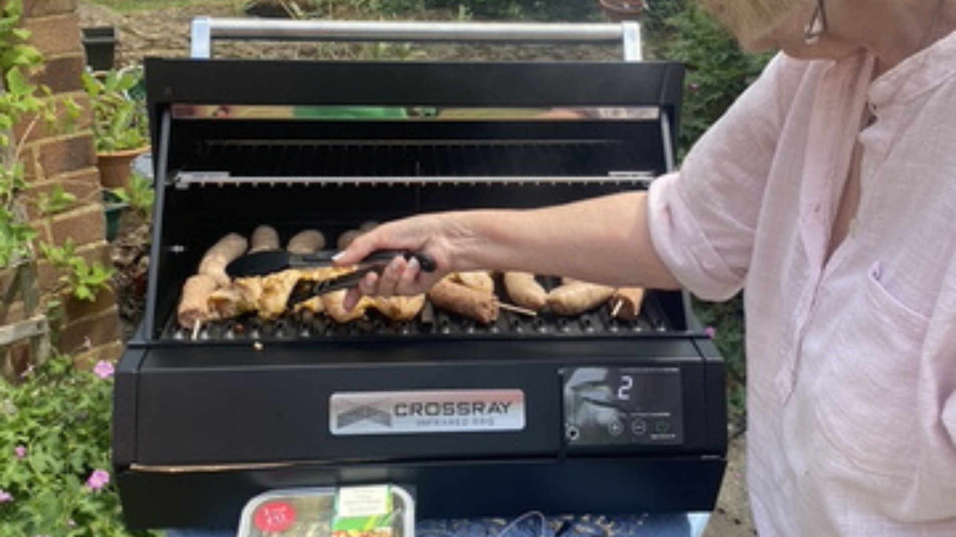 The Dimplex Crossray eXtreme Portable Electric BBQ being used to cook meat by our tester, Lesley