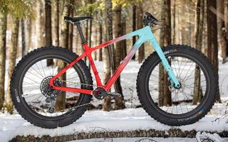 Salsa fat bike in a snowy location with a blue and red faded paint job