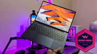 The HP EliteBook Ultra 14 (G1i) being held up by a hand. A Windows Central Editor's Choice award is in the bottom right corner of the image.