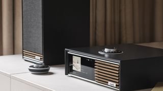 Ruark R610 and speakers close up on a wooden shelf in a minimalist room