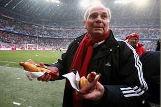 Uli Hoeness, President of Bayern Muenchen fried sausages for the supporters prior to the Bundesliga match between Bayern Muenchen and Hertha BSC Berlin at the Allianz Arena on December 19, 2009 in Munich, Germany.