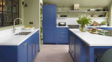 A kitchen with blue painted kitchen cabinets