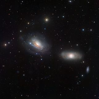 This image captures the pair of galaxies NGC 3169 (left) and NGC 3166 (right). These adjacent galaxies display some curious features, demonstrating that each member of the duo is close enough to feel the distorting gravitational influence of the other. Th