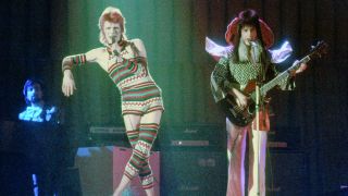 LOS ANGELES - 1973: Musician David Bowie performs onstage with bass player Trevor Bolder (1950-2013) during his "Ziggy Stardust" era in 1973 in Los Angeles, California. (Photo by Michael Ochs Archives/Getty Images)