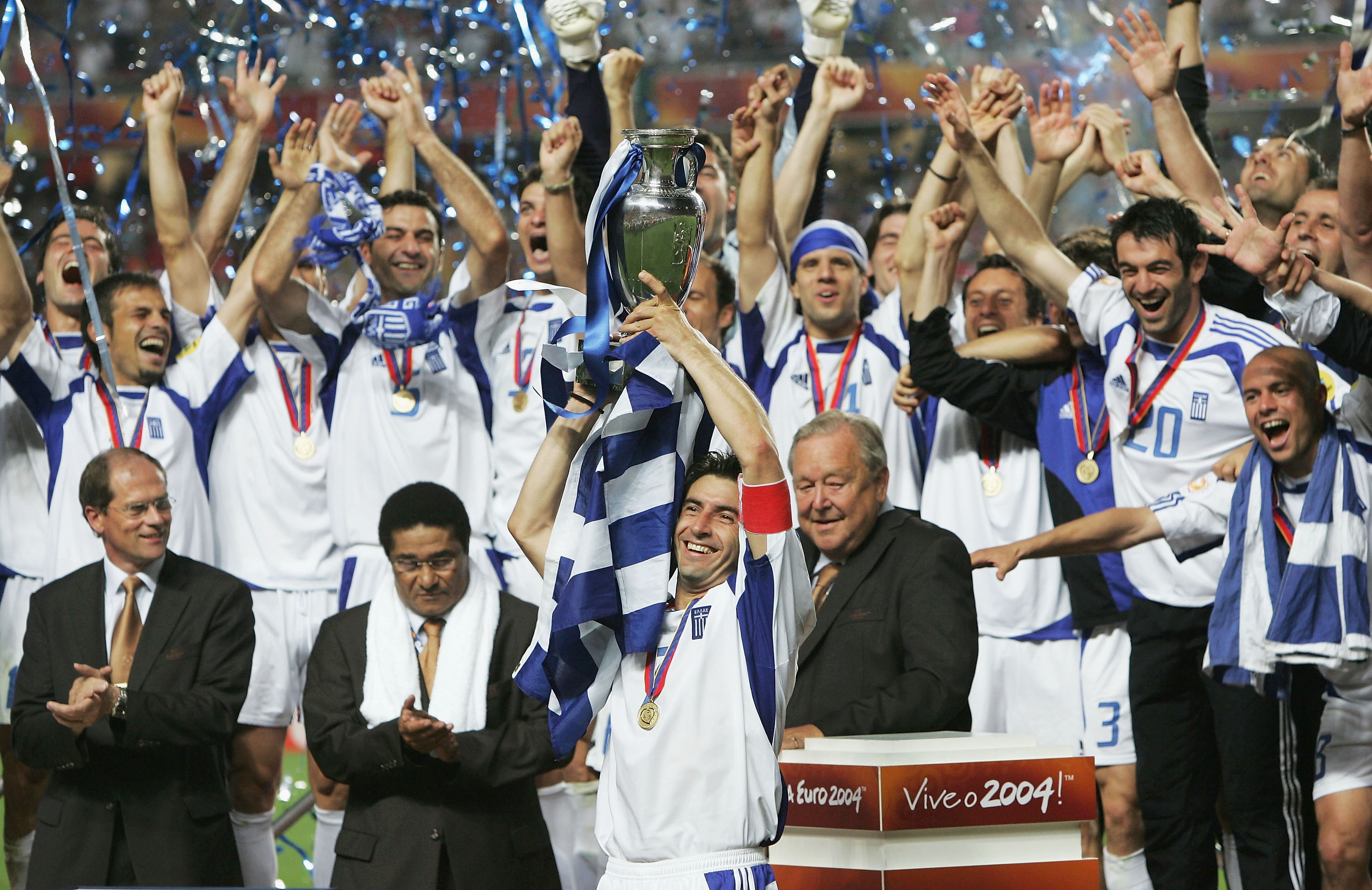 Theo Zagorakis lifts the European Championship trophy as Greece players celebrate victory over Portugal in the final of Euro 2004.