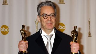 A photograph of composer Howard Shore holding his two Oscars for Lord of the Rings: The Return of the King