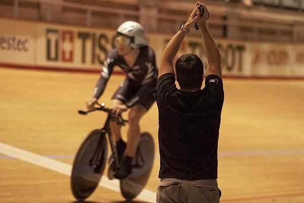 New Zealand's Shane Archbold seals the gold medal in the omnium after his ride against the clock, much to the delight of his team handler.