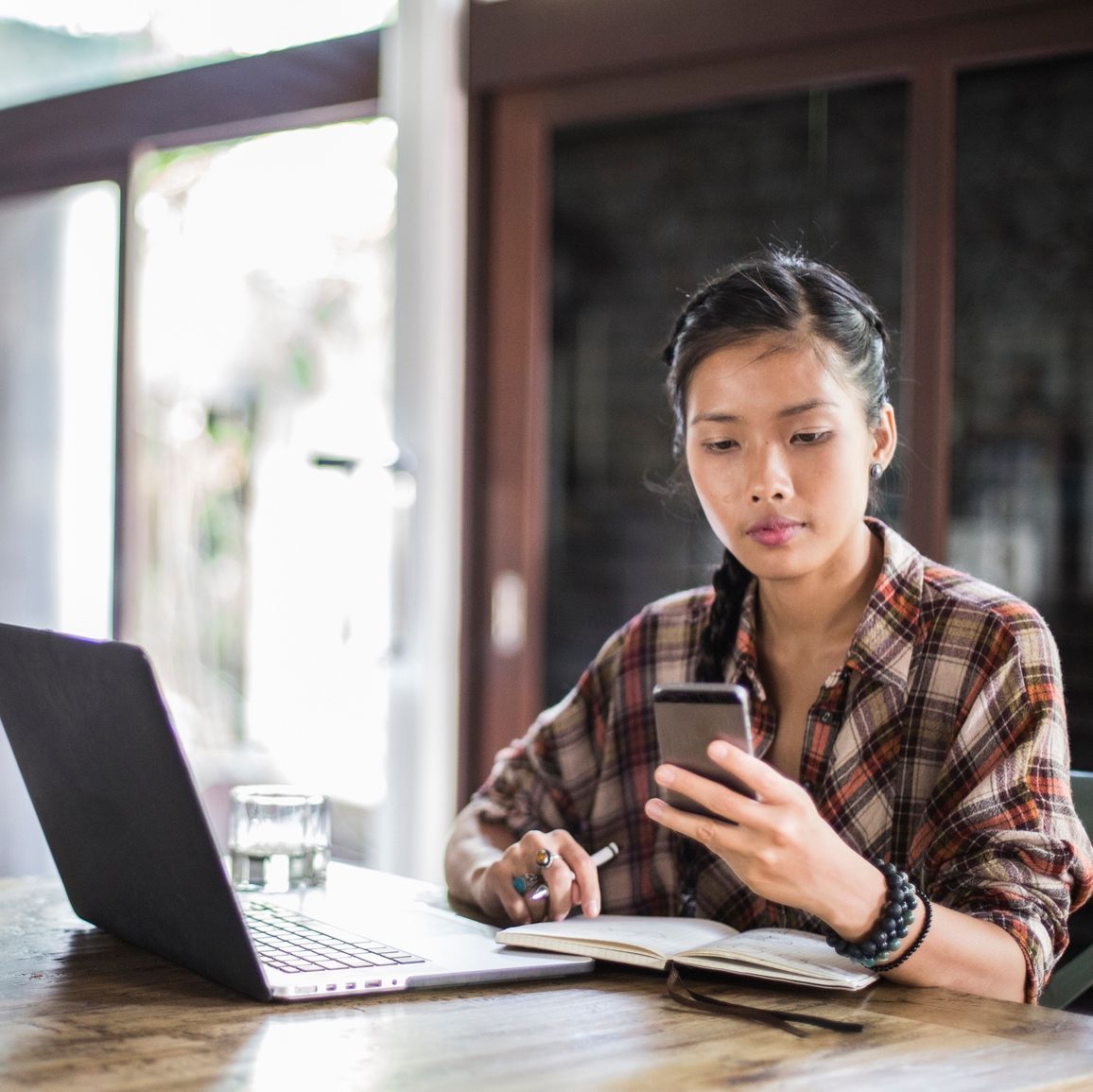 a young beautiful woman works at her laptop in a modern office space