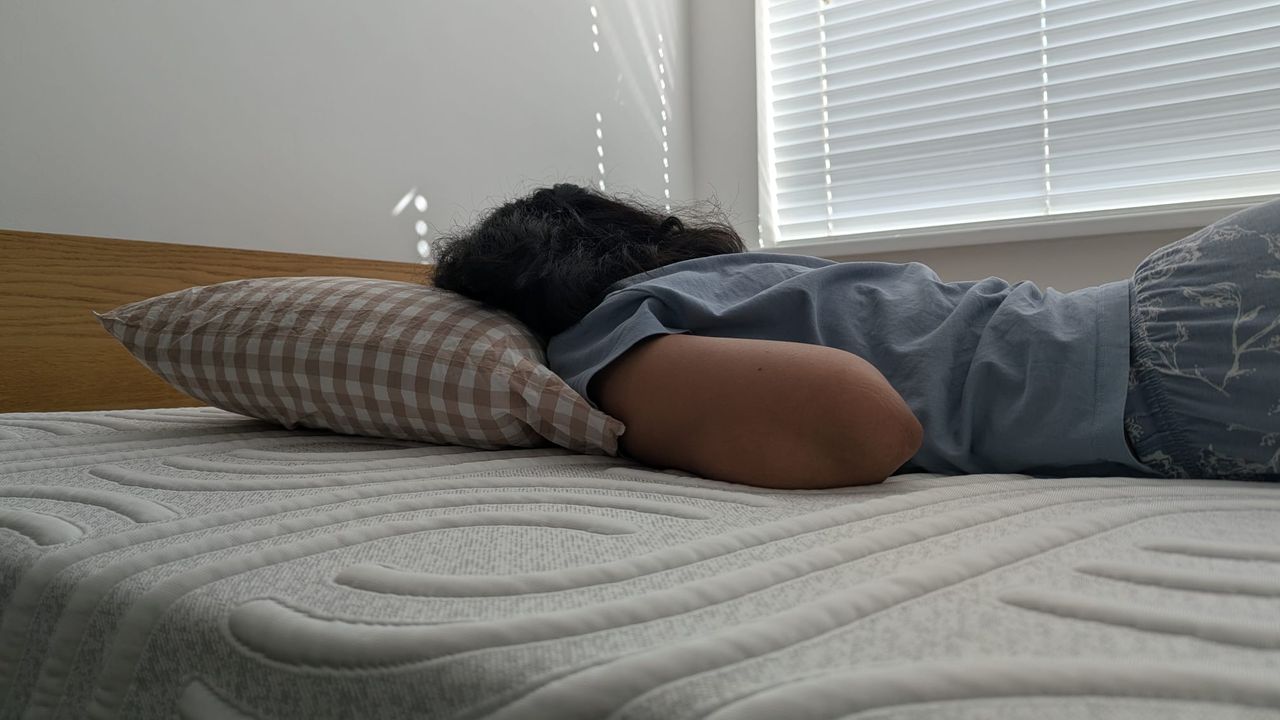 Our tester lying in the front, back and side positions to assess the comfort and support of the mattress