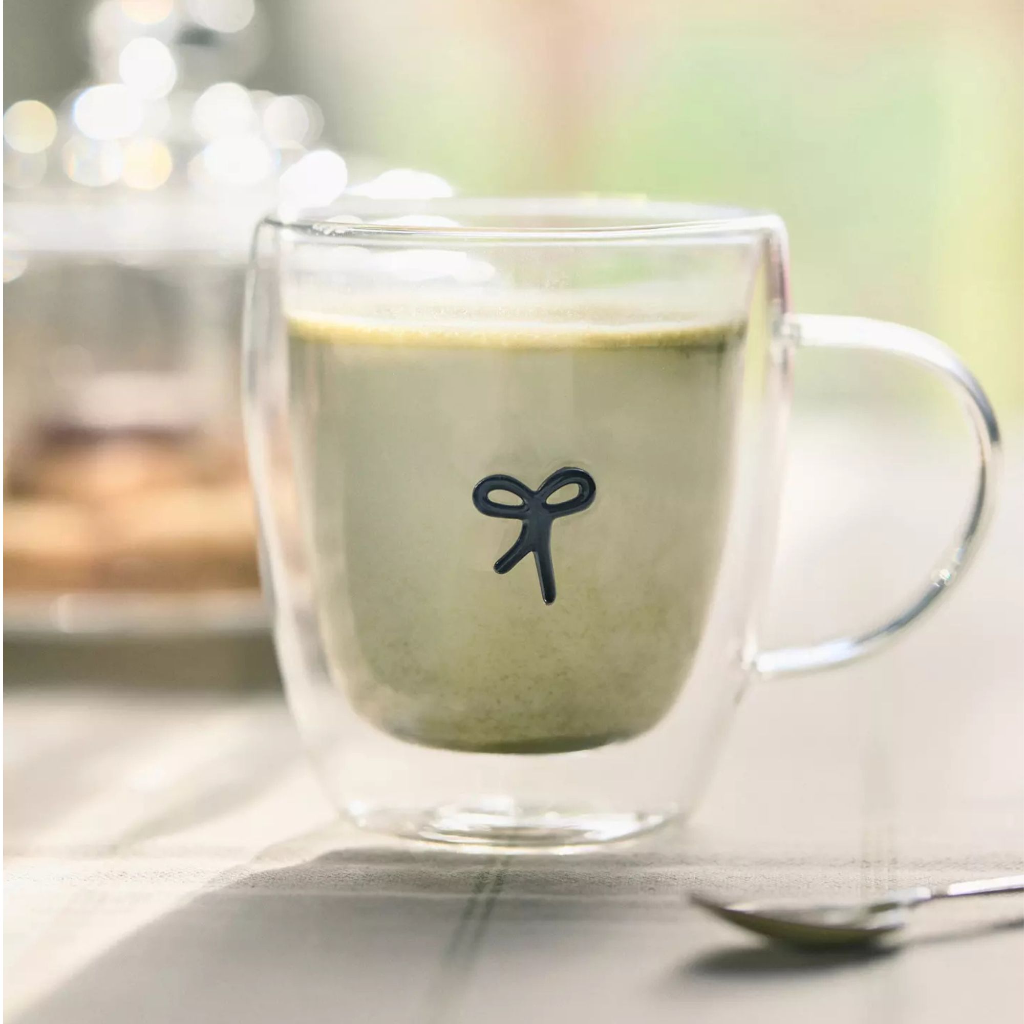 Glass mug with black bow design