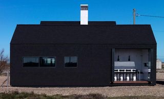 Shingle House black exterior with white chimney