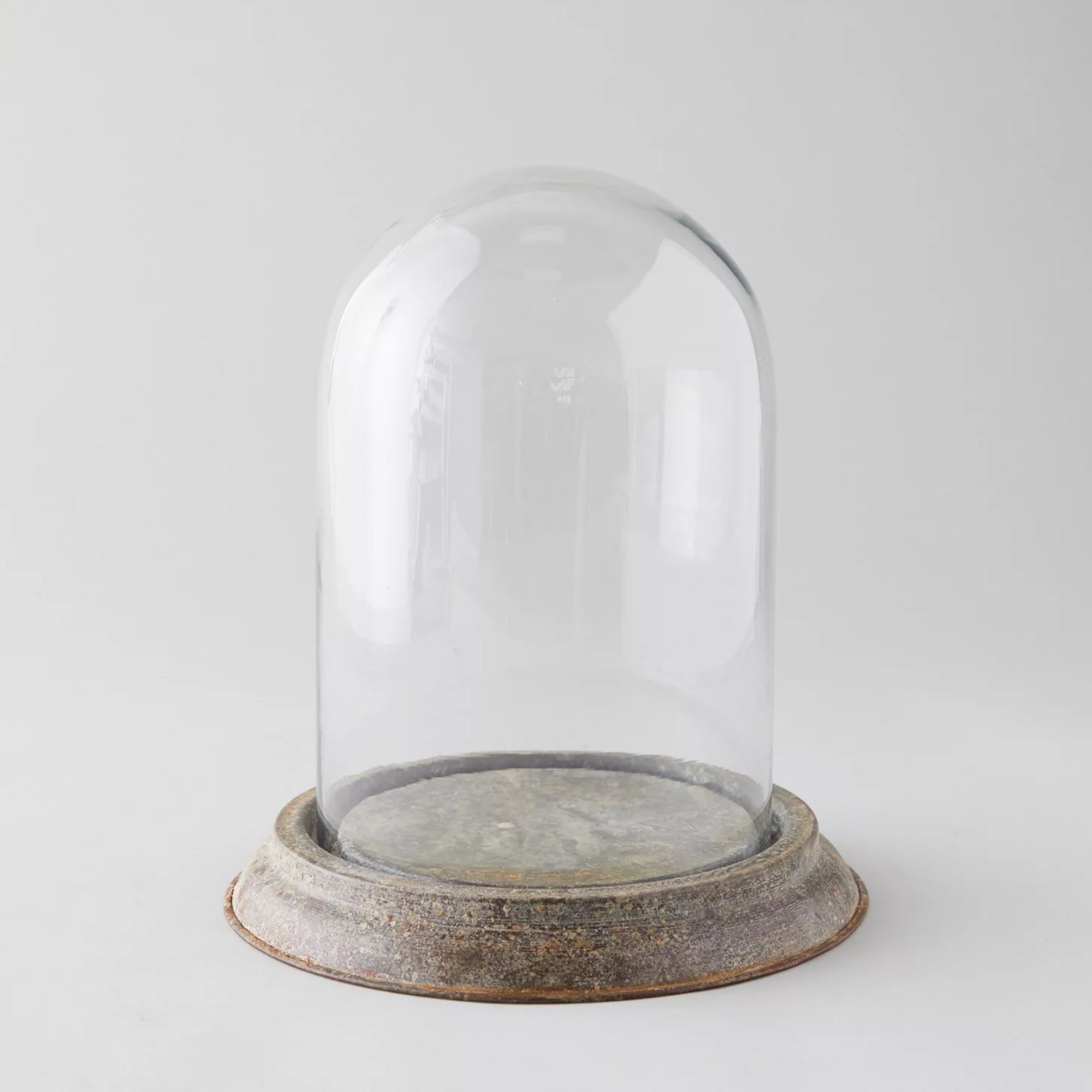 Glass cloche with distressed iron base
