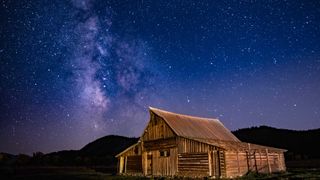 Milky way appearing over barn