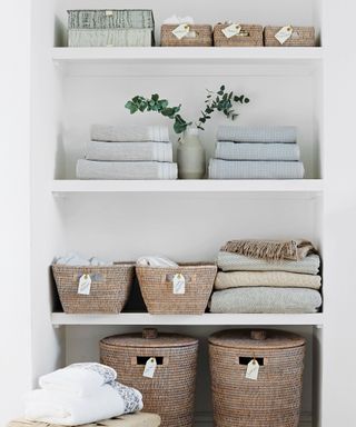 Shelves with labeled baskets, linens and towels