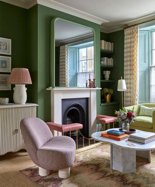 A green living room with a fireplace and seating arrangement